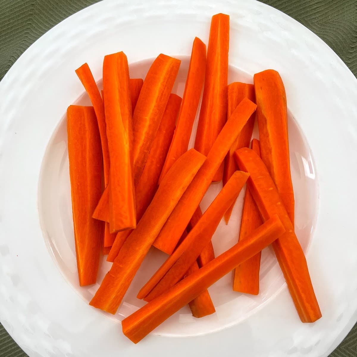 Fresh carrot sticks on a plate